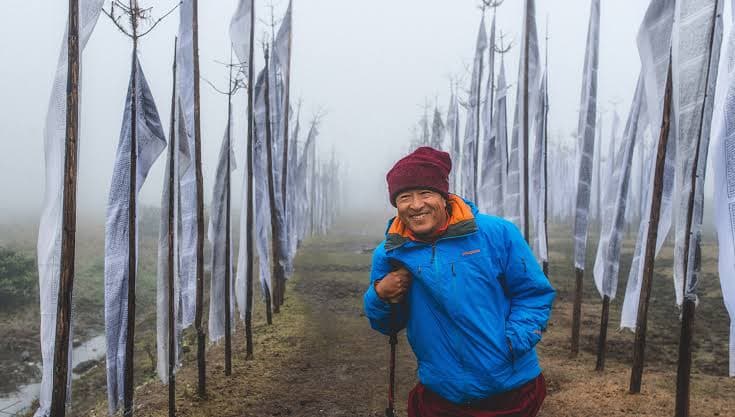 Dzongsar Jamyang Khyentse Rinpoche, the book’s author, on a prayer-flag path in the mist