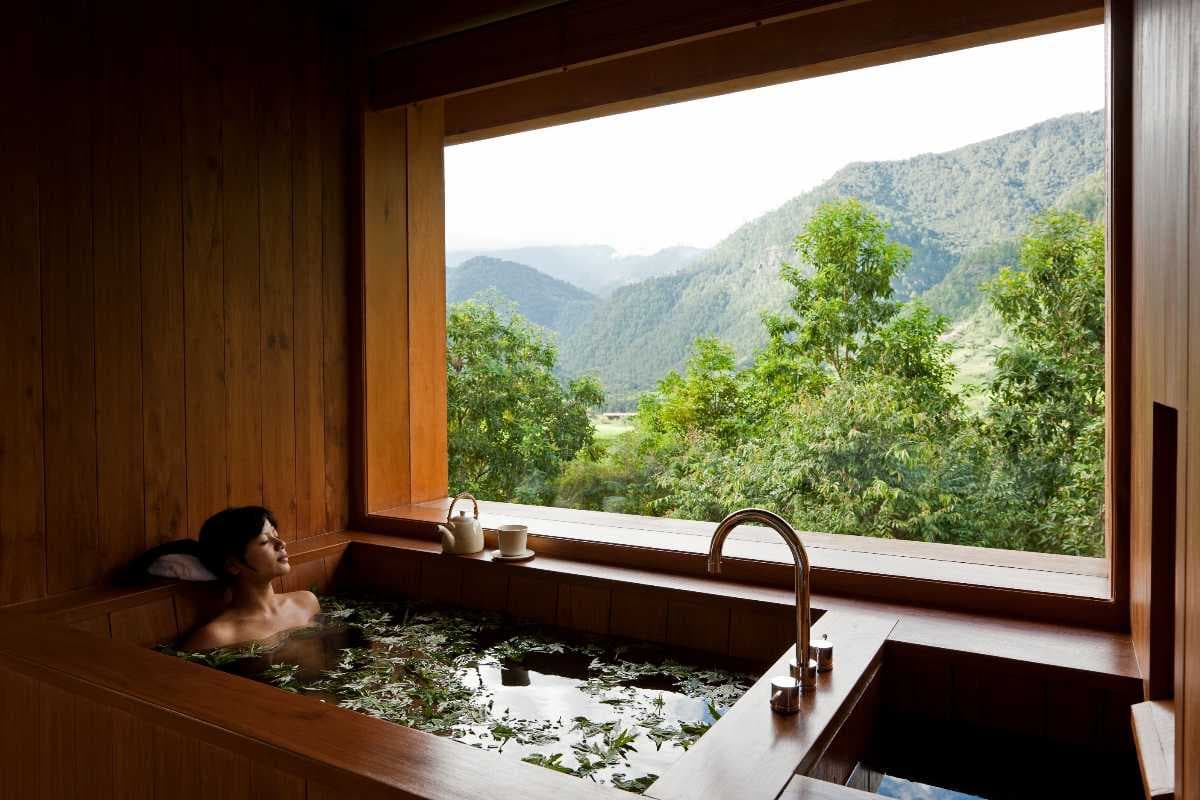 A Bhutanese hot stone bath — river stones, artemisia, and a wooden tub
